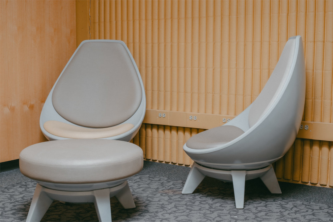 Photo of two futuristic chairs and a stool